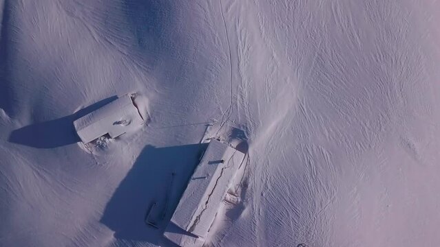 Drone footaget ofsnowy mountains and forest with cabins below. Achenkirch, Tirol, Austria