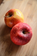 Red and yellow apples on wooden cutting board in the kitchen, healthy diet Vitamin C fruit