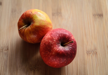 Red and yellow apples on wooden cutting board in the kitchen, healthy diet Vitamin C fruit