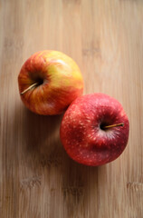 Red and yellow apples on wooden cutting board in the kitchen, healthy diet Vitamin C fruit