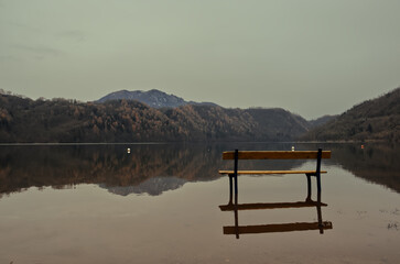 A wooden bench in the lake of Levico Terme.
