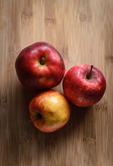Red and yellow apples on wooden cutting board in the kitchen, healthy diet Vitamin C fruit