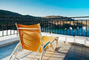 Sun lounger on the roof of a house with a wonderful view. Concept of rest.