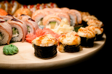 Focus on foreground of fried sushi rolls with filling on top