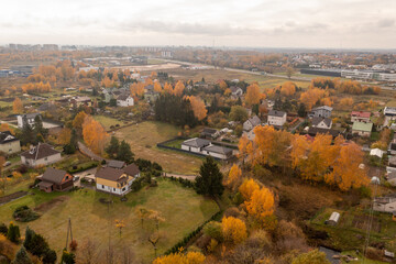 Fototapeta na wymiar Drone photography of city suburbs landscape with low density houses during autumn day