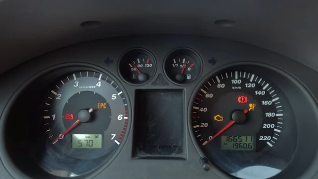 image of a car instrument panel, showing various gauges and warning lights that indicate a serious malfunction in the vehicle. The tachometer, speedometer, odometer, fuel gauge, and temperature gauge