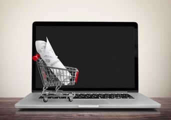 Laptop computer and shopping cart on desk