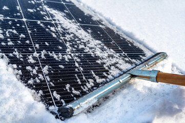 Zugeschneite Photovoltaikanlage wird vom Schnee befreit
