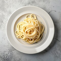 A plate of cooked spagetti pasta on a table.