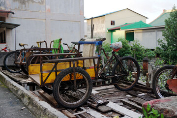 an old rusty rickshaw that still operates to transport goods from the harbor