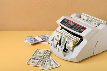 Modern cash counting machine with dollar banknotes on color background - obrazy, fototapety, plakaty