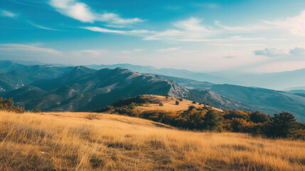 Golden hills with distant mountain range.