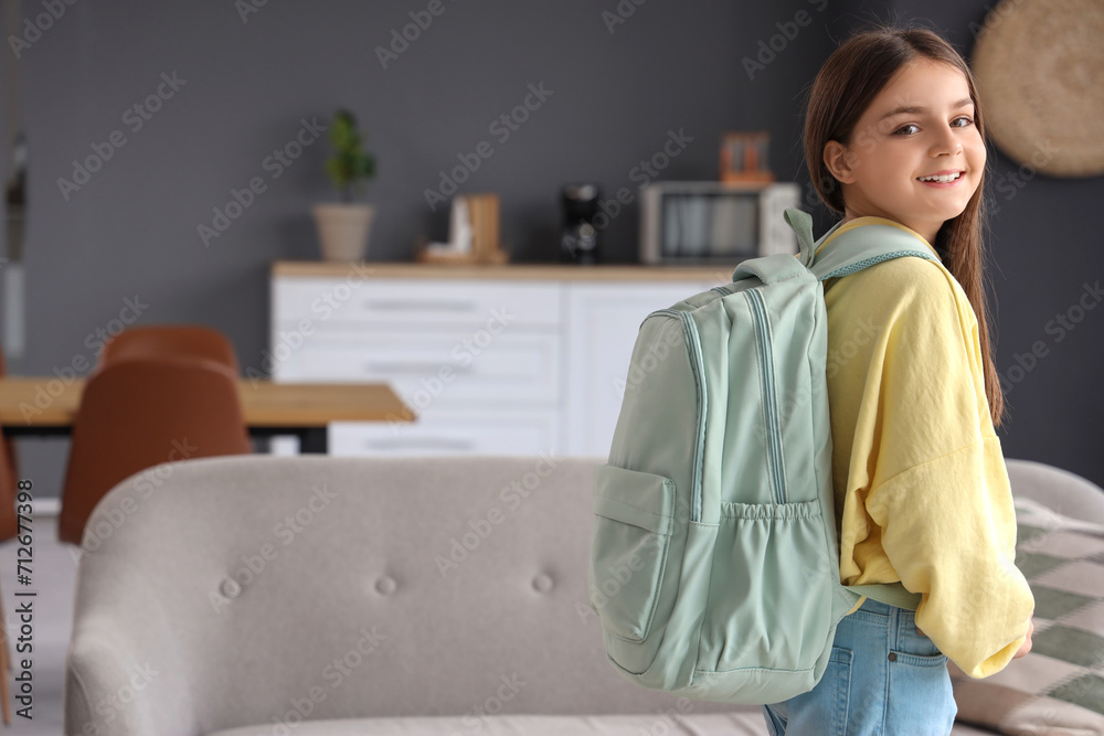 Poster Little schoolgirl with backpack at home