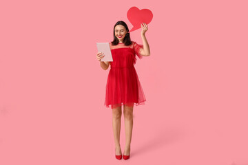Young woman with tablet computer and speech bubble on pink background. Online dating