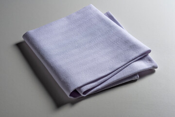 Perspective view of folded light blue napkin