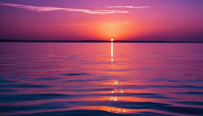 Sunset over the ocean viewed from the rear of a boat with waves in the foreground