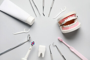 Frame made from dental tools, oral hygiene supplies and plastic models on white background. World...