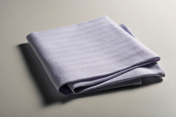 Perspective view of folded light blue napkin