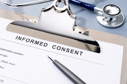 Informed Consent form pen and stethoscope on desk