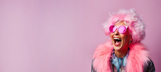 Happy laughing funny woman of old senior age, pink banner background with copy space
