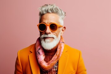 stylish senior man in orange sunglasses and scarf, isolated on pink - obrazy, fototapety, plakaty