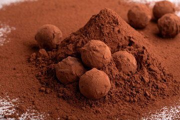 Horizontal photography a heap of handmade dark chocolate truffles adorned with cocoa powder. This confectionery masterpiece combines the rich flavors of dark chocolate and sugar