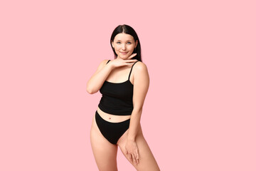 Fototapeta na wymiar Body positive young woman in underwear on pink background