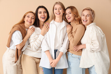 Fototapeta premium Portrait of beautiful women on beige background