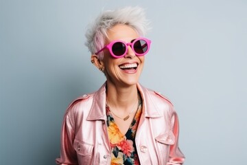 Portrait of a beautiful young hipster woman with pink hair and sunglasses