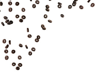 Chocolate rings cereal spill out into a bowl. Breakfast.