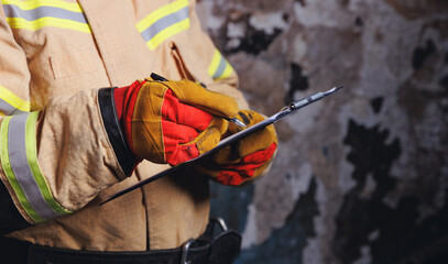 Fireman inspector conducts investigation to determine circumstances of fire in house and uses...