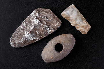 Prehistoric stone axe, isolated on black background.primitive man.Scythian period.Archaeology....