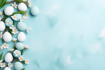 Light blue and white colored easter eggs with blossom cherry  on pastel blue Easter background with copy space.