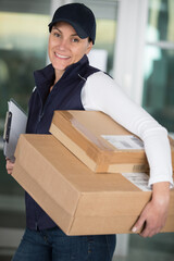 portrait of a female delivery worker holding parcels