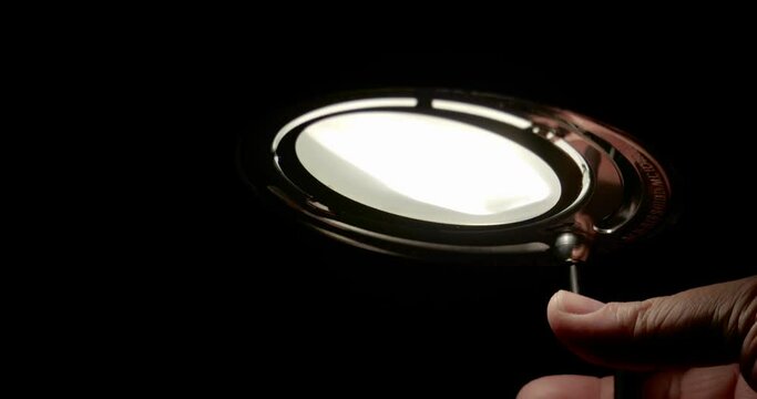 Men turning off lamp / Slow motion