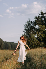 Fototapeta na wymiar A person standing in a field of tall grass wearing a white dress. 5643