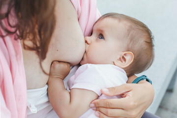 close-up mother breastfeeding baby outdoor
