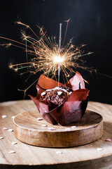 Festive chocolate muffin with sparkler.