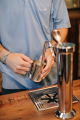barista steaming milk for coffee