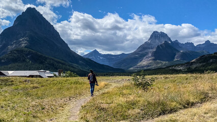 Fototapeta na wymiar Woman Hiking around Swiftcurrent Lake in Many Glacier Region of Glacier National Park