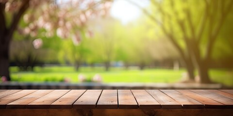 Wooden table with space for decoration and blurred background of park during spring.