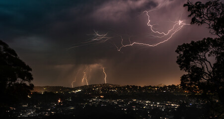 Lightning Strikes at night during a storm over houses in the northern beaches of Sydney, Australia