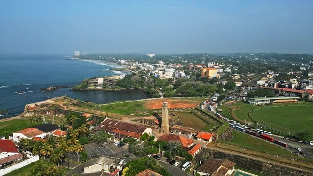 Aerial view of Galle, Sri Lanka, showcasing the historic fort, cricket stadium, coast and urban landscape with verdant tropical fauna, a blend of heritage and modernity.