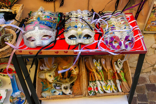 Souvenir stand with masks,wooden spoons and ceramic items in Sirmione, Italy.

