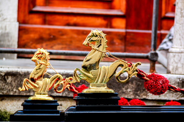 Detail of shiny brass mythological Hippocampus sea horse ornament which adorns both sides of the passenger seat of gondolas in the canals of Venice, Italy.
