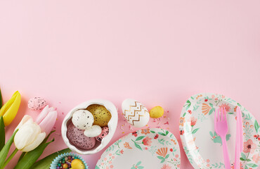 Springtime delights: Children's Easter celebration adventure. Top view photo of colorful plates, eggs, cutlery, tulips, sugar sprinkles on pastel pink background with advert space