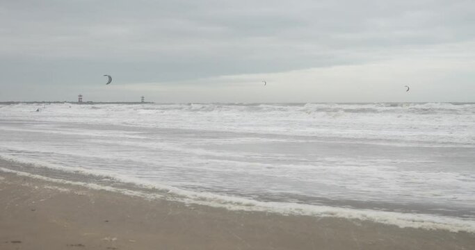 Keizerstraat, 2586 ZZ Den Haag, Netherlands - December 23, 2023: North sea in winter. Surfers on the background.