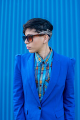 Young woman dressed in blue suit with androgenic hair style