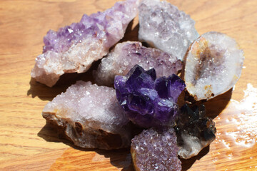 Beautiful purple druzy with amethyst crystals on a wet wooden background. Magical semi-precious...