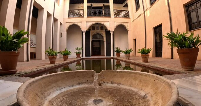 Beautiful arabian fountain in Granada, Spain, in a traditional coutryard or patio